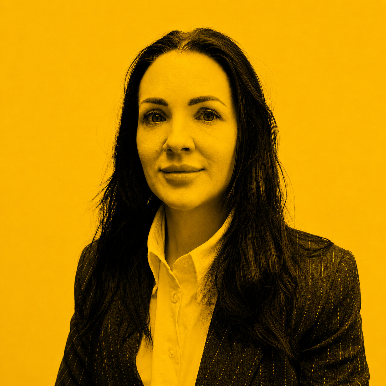 Professional headshot of a woman with dark hair wearing a pinstripe blazer and white shirt, looking at the camera.